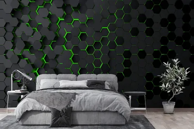 Green light leaks through the seams of a black hexagon feature wall above a grey bed, with an olive tree filling the right corner.