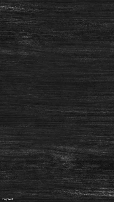 Long vertical grain runs the height of a tall frame in near-black timber, a few pale scratches breaking the surface near the top.
