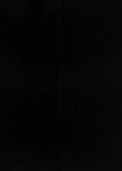 Dark card photographed flat, a faint vertical crease running down the middle and a slight tonal shift where the two halves meet.