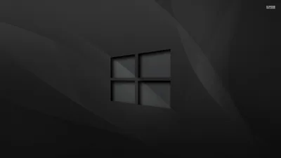 The Windows outline etched into a slate grey background with soft diagonal folds running behind it like brushed cloth.
