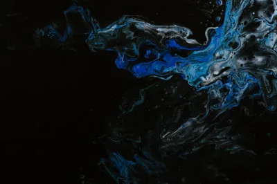 Streams of silver and blue paint drift in from the top edge, while the left half and bottom sit in flat black ready for icons.