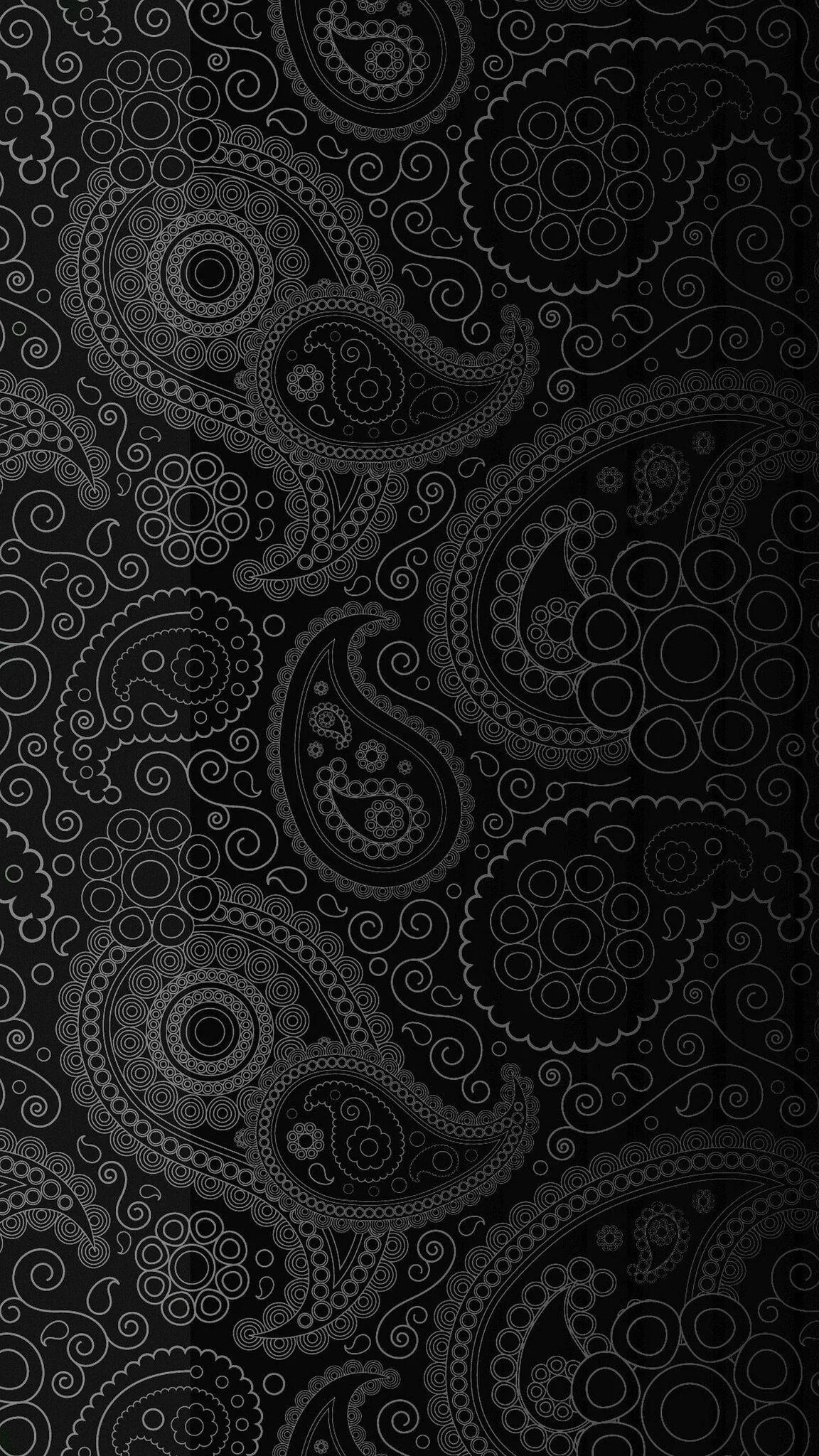 Paisley teardrops and dotted rosettes repeat down the frame in near-black tones, the fine outlines only visible when the screen is turned up.