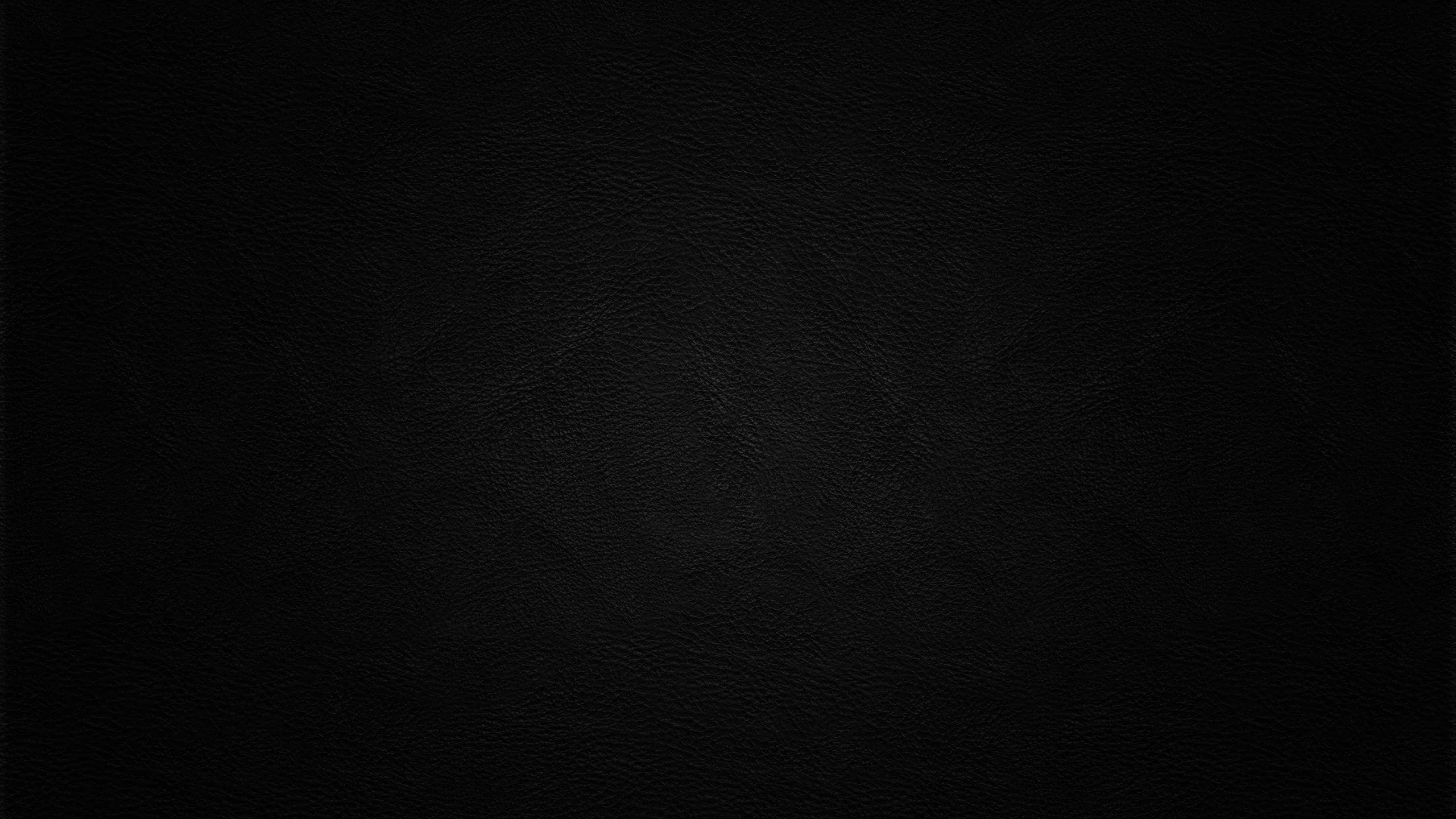 A faint fabric weave covers the whole frame and lifts slightly at the centre, everything else sitting close to true black for OLED panels.