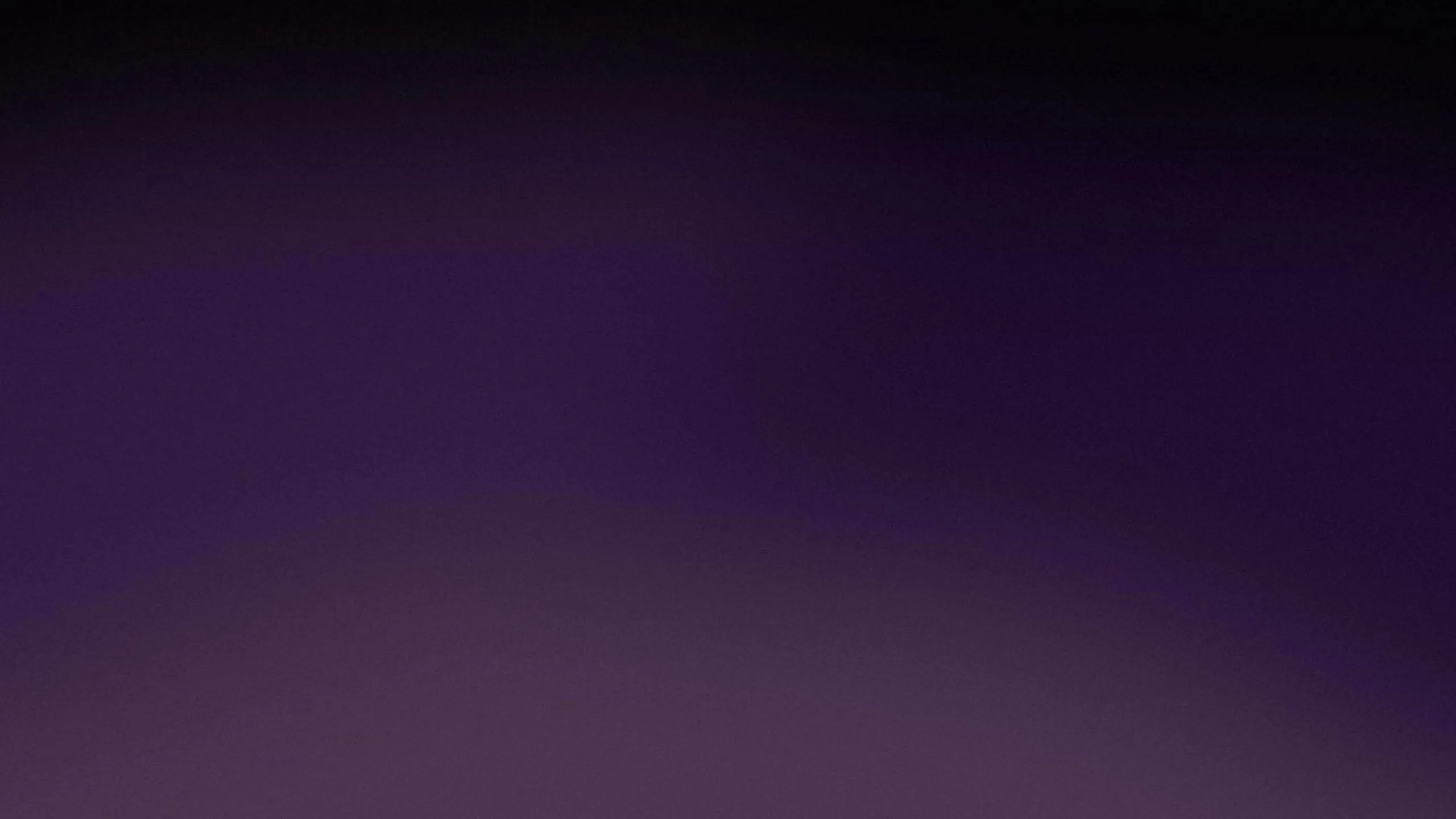 Muted violet spreads through the lower half and fades out to black at the top, the transition soft enough to leave the frame clear.
