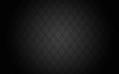 A quilted diamond lattice with a small flourish in each cell glows through the centre of the frame while the border drops to solid black.