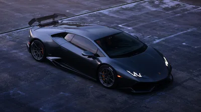 Shot from a high angle on bare concrete, the matte finish shows almost no reflection — the rear wing, roof scoop and bronze brake calipers carry the detail.