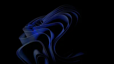 The folded ribbon shape of the Windows 11 bloom rendered in deep blue, its edges lit against a fully black background.