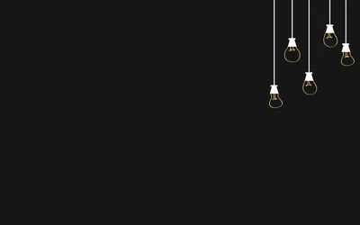 Five filament bulbs drop on thin white cords from the top right corner, warm and small against a wide sweep of empty dark grey.