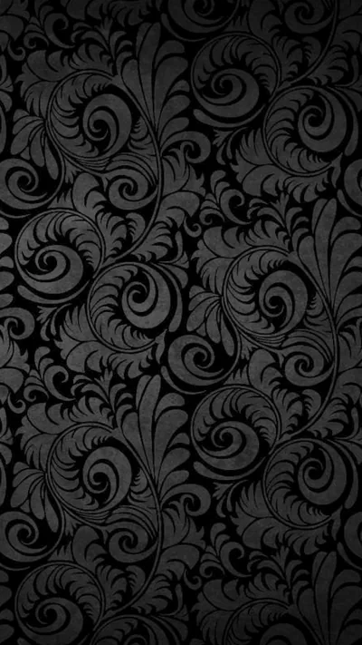 Curling floral scrollwork repeats edge to edge in charcoal on black, raised just enough that the light picks out each spiral.