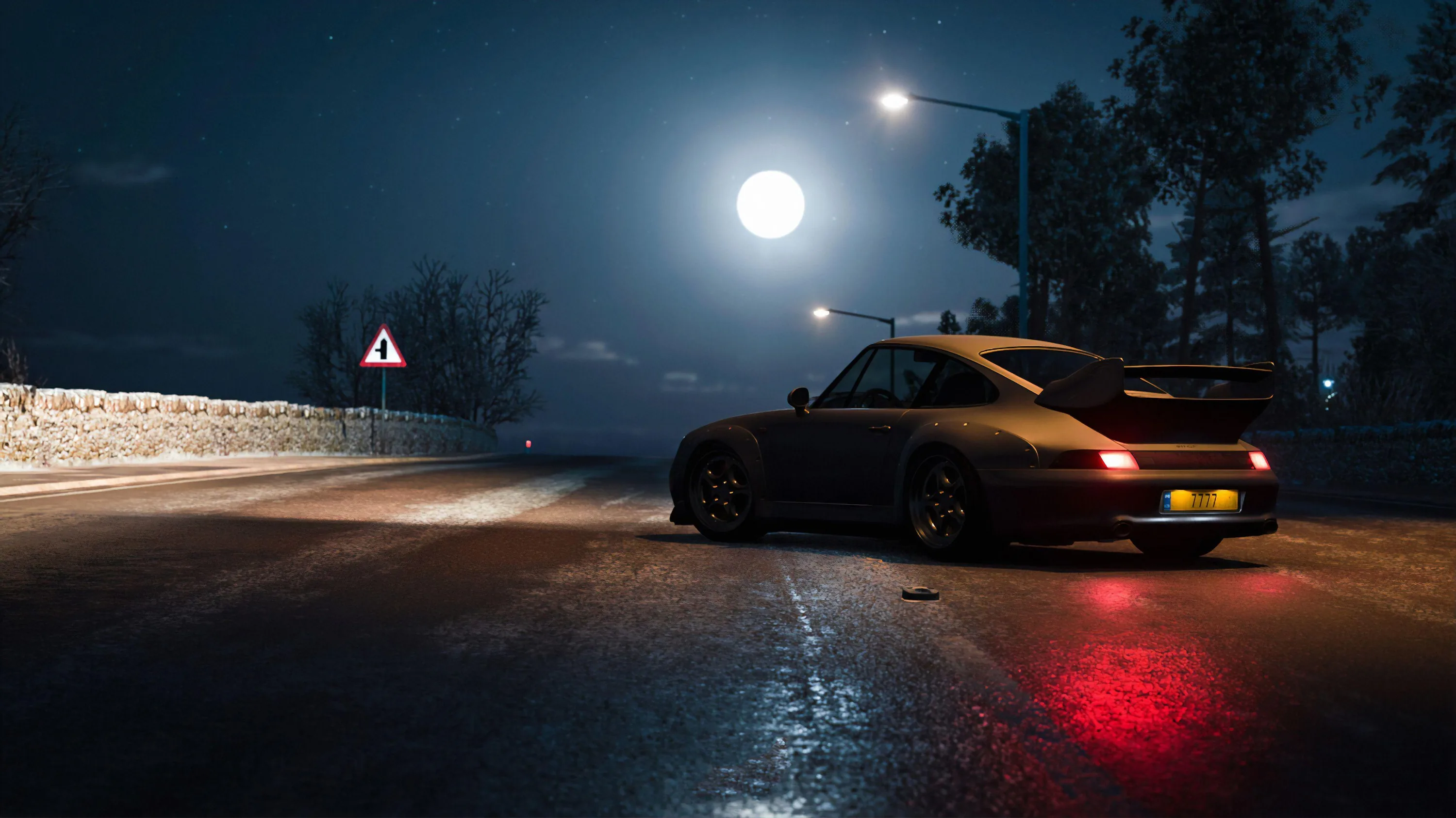 A classic 911 sits on a rain-slicked mountain road at night, a full moon and one streetlight throwing long reflections down the empty lane.