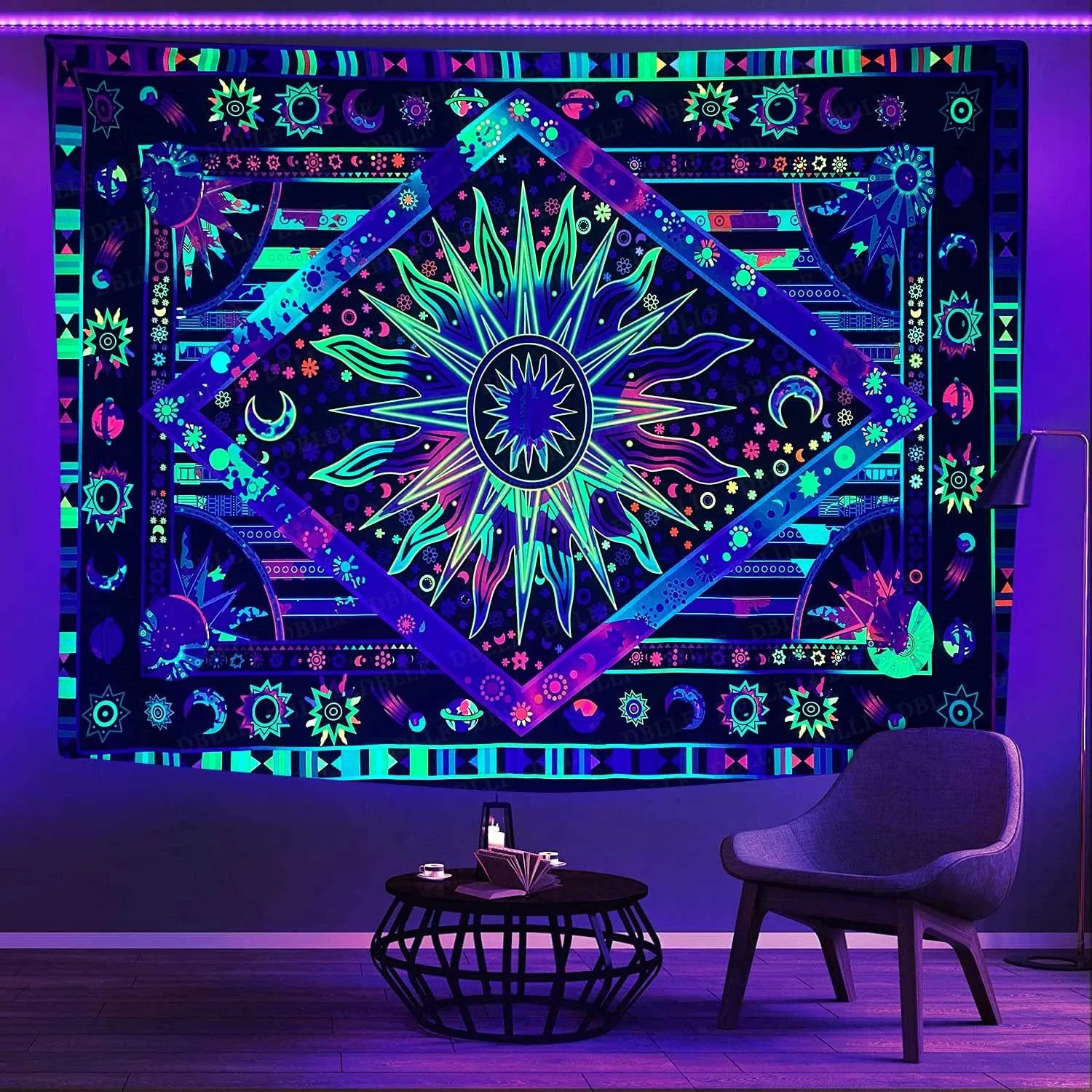A sun-and-moon mandala tapestry glows teal and green under a purple LED strip, with a chair and round coffee table sitting in the lower-right of the room.