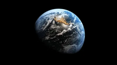 White cloud bands wrap the globe with a patch of orange desert breaking through, the planet set slightly right of centre on solid black.