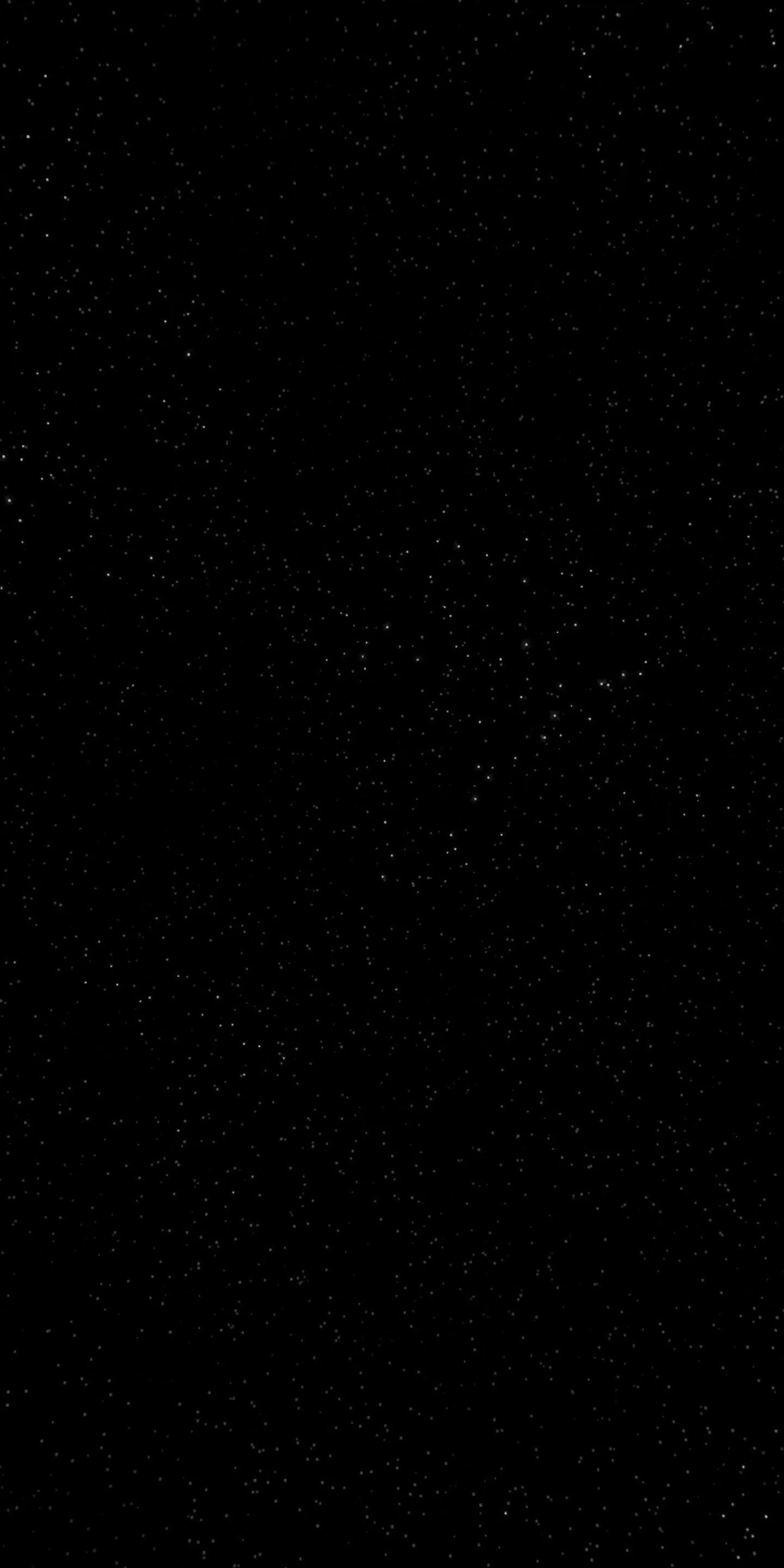 Almost the entire frame is unbroken black, with tiny star specks surfacing only when the screen is turned up.