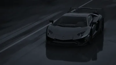 Desaturated to near monochrome, the SV crosses a rain-covered road with its rear wing raised and reflections stretching under the tyres.