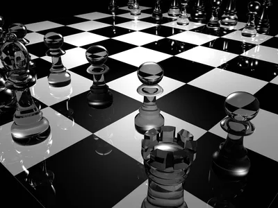 Transparent chess pieces catch hard light on a chequered surface, shot low from behind a rook so the board recedes into black.