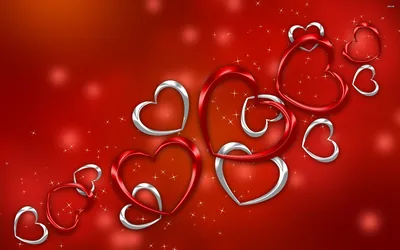 Chrome and ruby heart outlines interlock in a diagonal chain from lower left to upper right, floating over a bright red field dusted with sparkles.